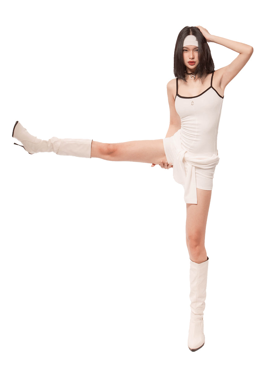 Woman in a white outfit with black trim posing on a white background