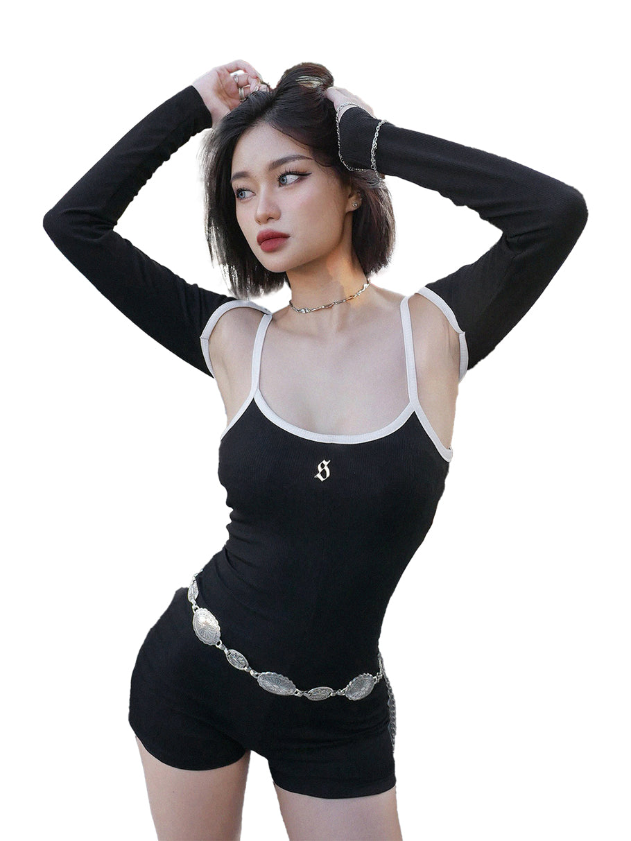 Woman wearing a black outfit with sheer top and shorts on a white background