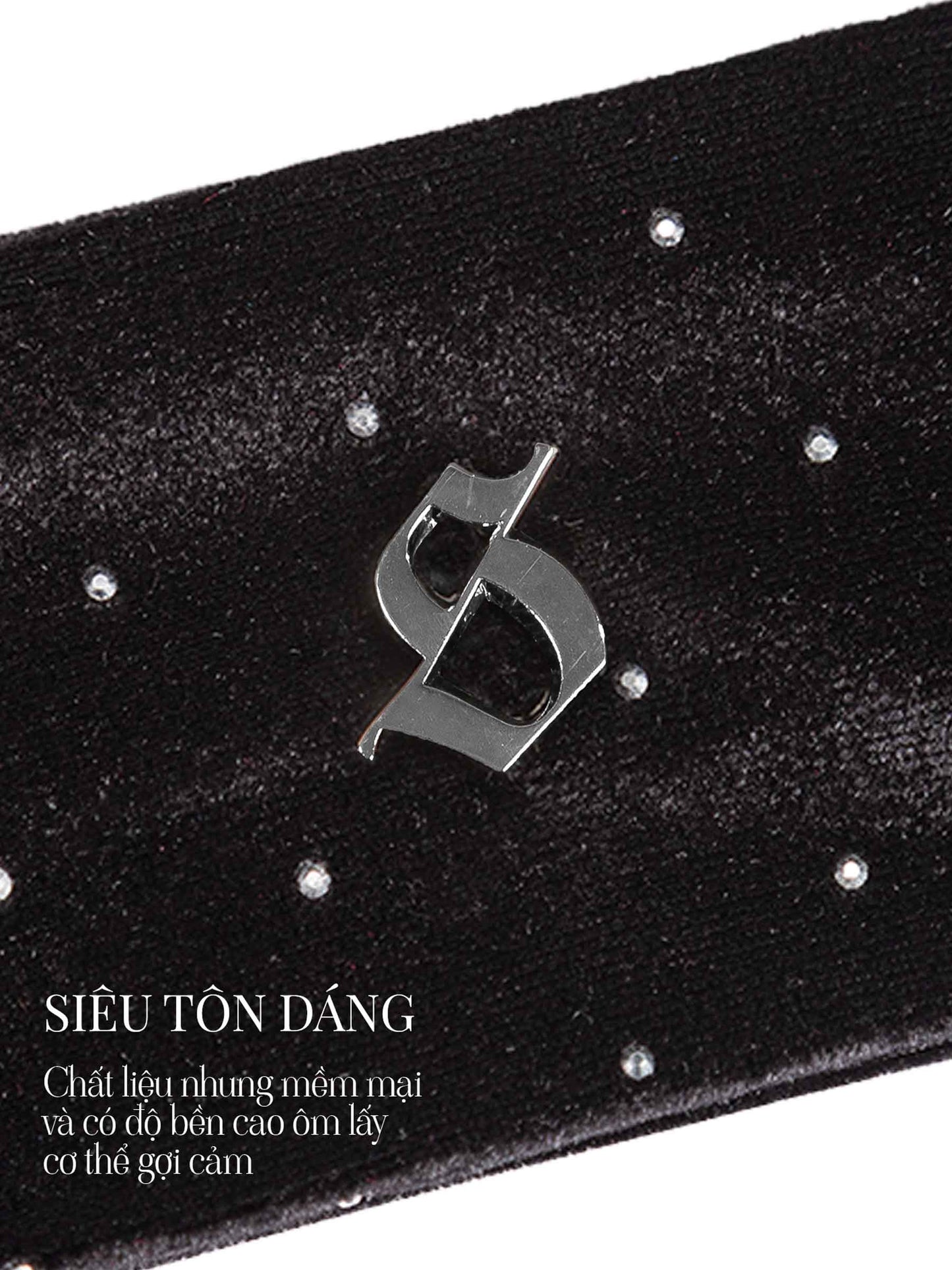 Black belt with a metallic logo and sparkling stones on a white background