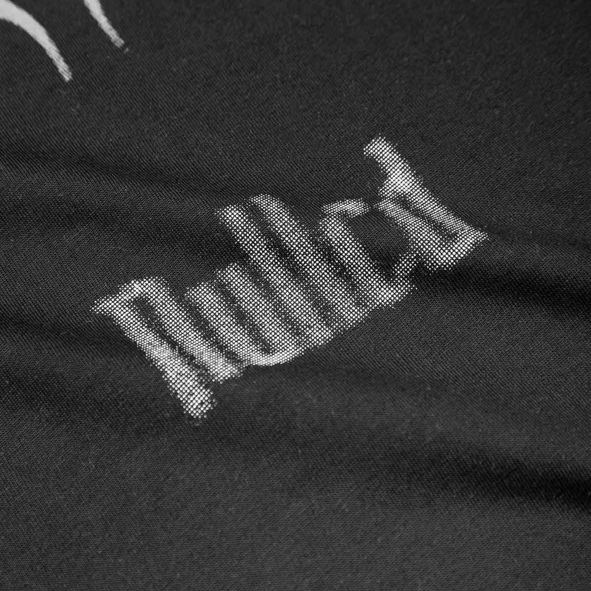 Close-up of a black fabric with white text on a black background
