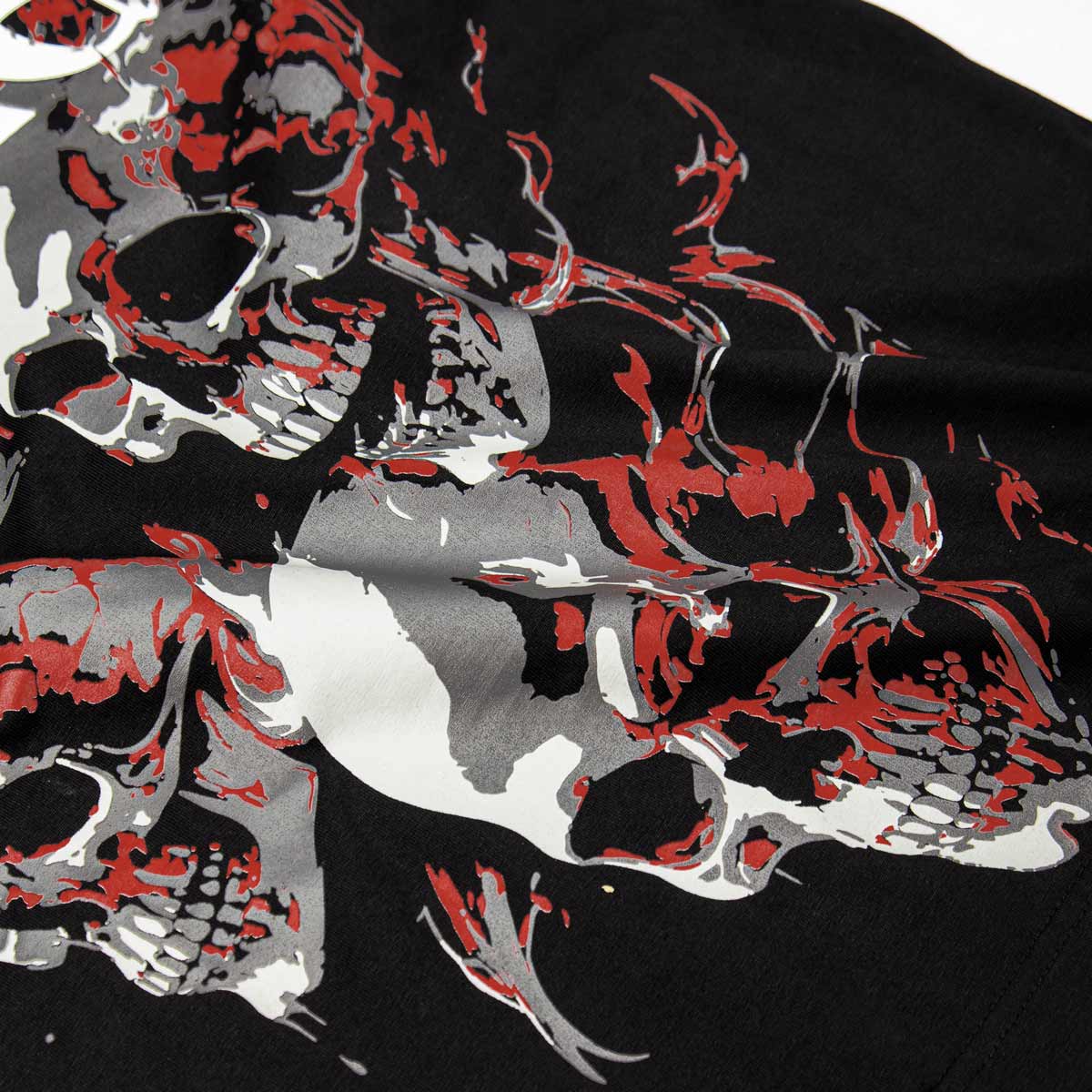 Fabric with red, gray, and white skull pattern on black background