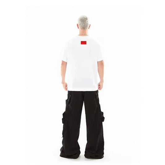 Person wearing a white t-shirt with a red logo and black cargo pants on a white background