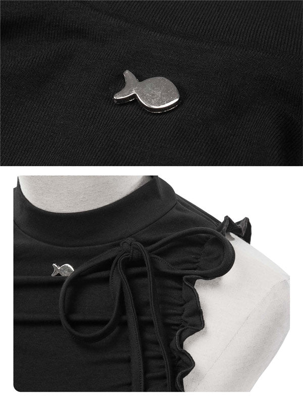 Black blouse with decorative bow and small silver fish-shaped brooch on a white background