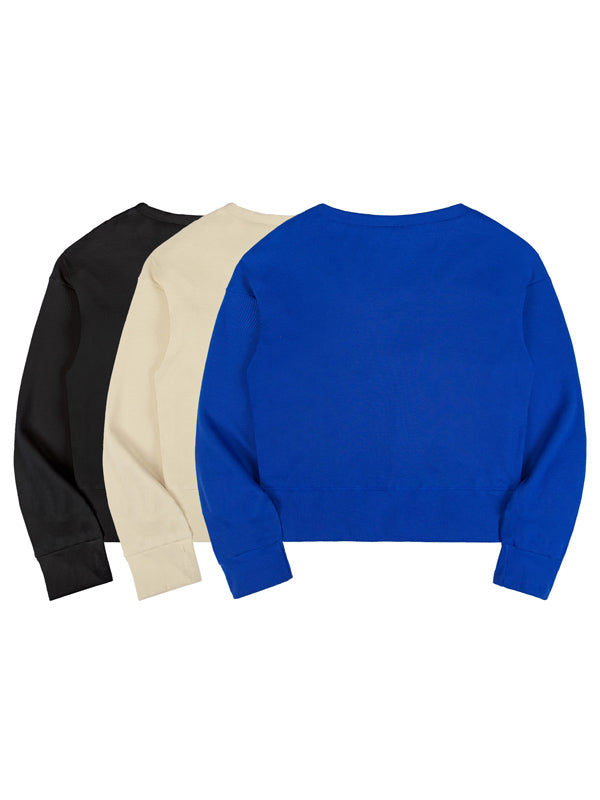 Three long-sleeve shirts in black, beige, and blue on a white background