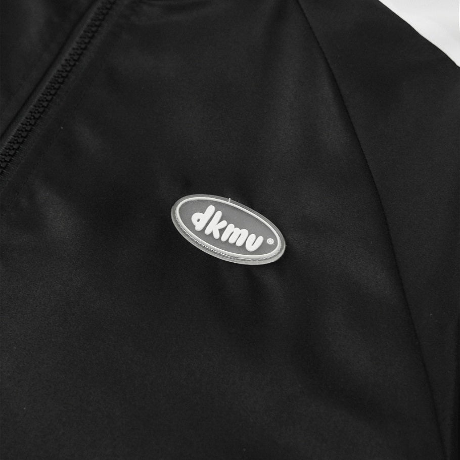 Black jacket with a silver logo on a white background