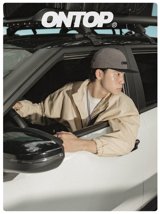 Person leaning out of a car window with 'ONTOP' branding above.