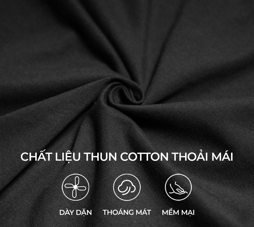 Close-up of black fabric with text indicating cotton material properties.