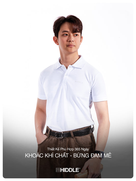 Man wearing a white polo shirt and brown pants against a white background