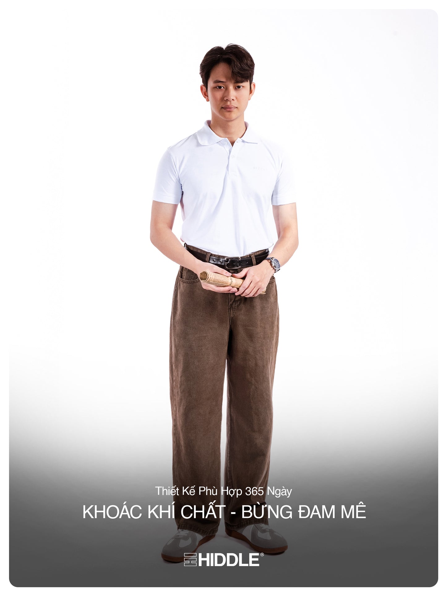 Man wearing a white shirt and brown pants on a white background