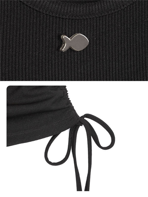 Black ribbed sweater with a silver fish-shaped button and tied hem on a white background