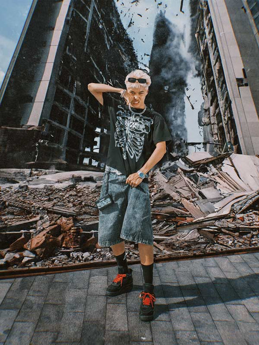 Person posing in front of a large mural of a destroyed building