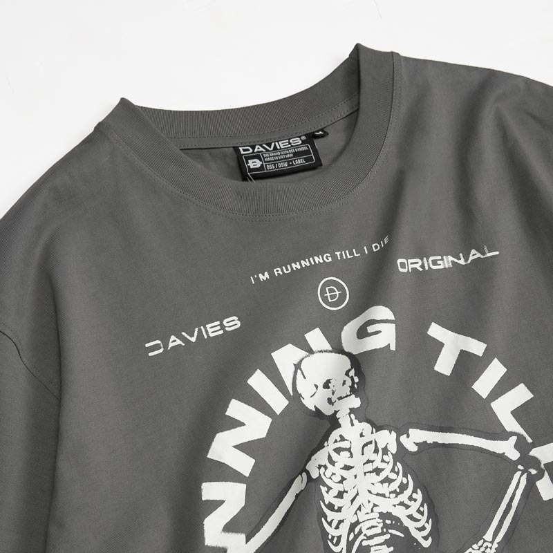 Gray t-shirt with skeleton graphic and text on a white background