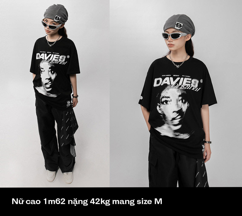 Person wearing a black t-shirt with a graphic design on a white background