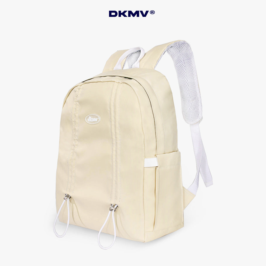 Beige backpack with white straps on a white background, featuring the brand 'DKMV'.