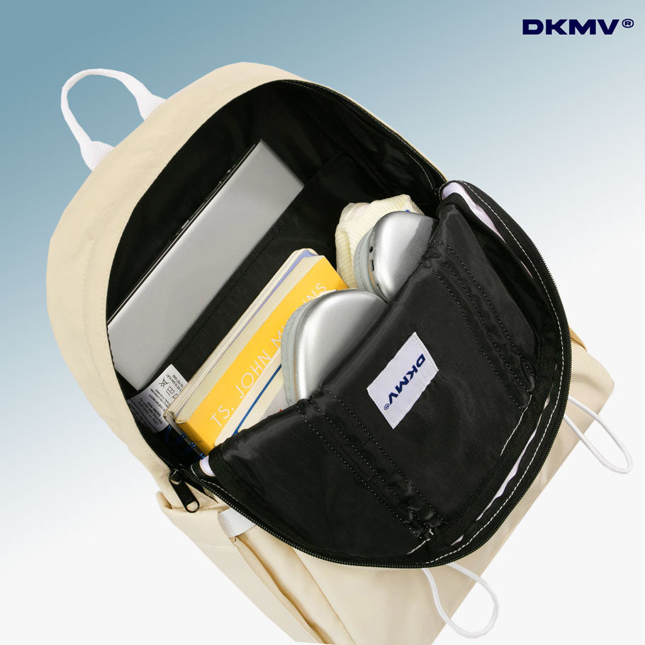 Beige backpack with a black compartment containing a laptop, notebook, and phone, on a light blue background with DKMV branding.