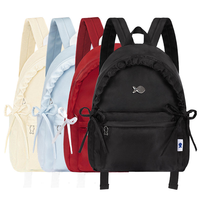 Four backpacks in different colors on a white background