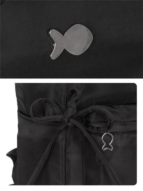 Black jacket with fish-shaped metal emblem on a dark background