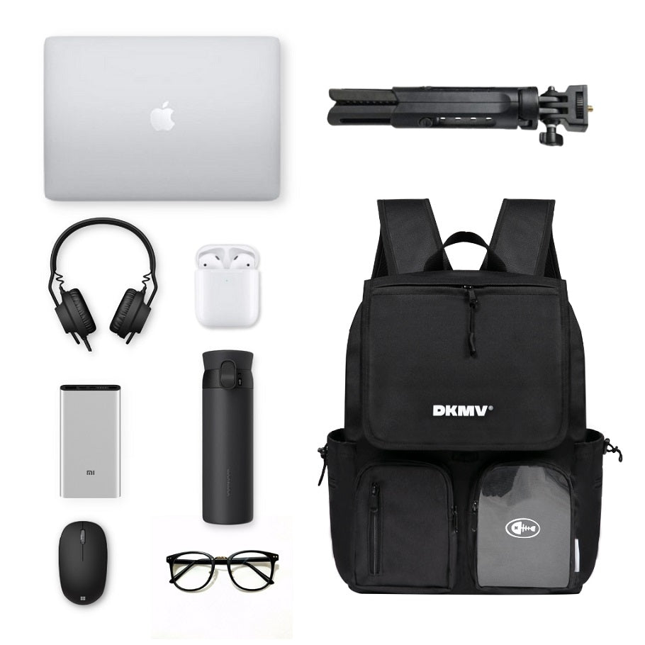 Black backpack with various items including a laptop, headphones, and a water bottle on a white background.
