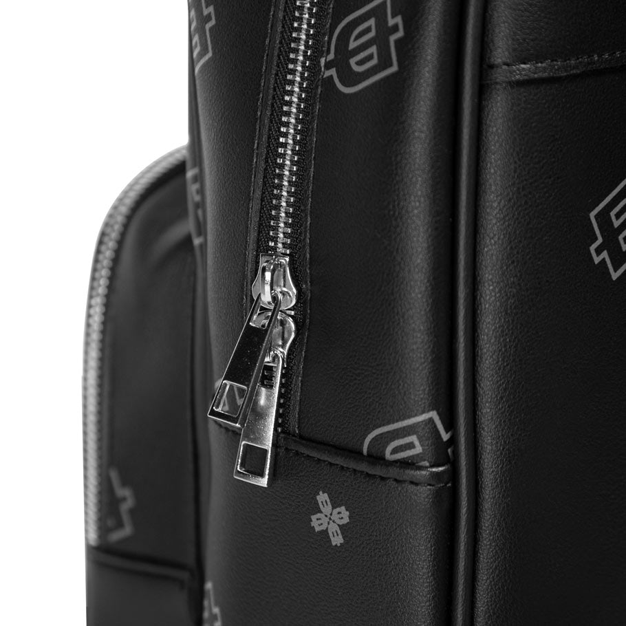 Close-up of a black backpack with a zipper and brand logo on a white background