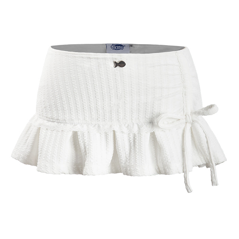 White skirt with ruffled bottom and tie detail on a white background