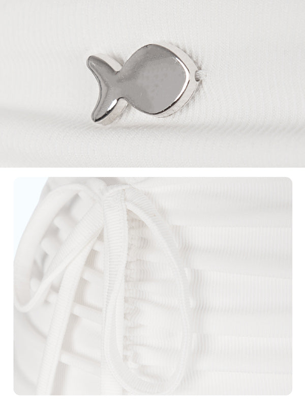 Silver fish-shaped object on a white background