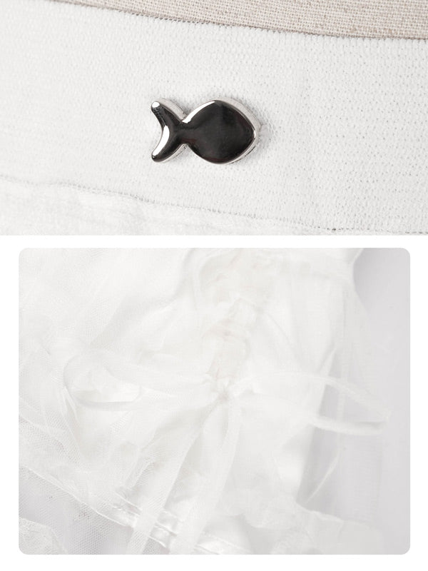 Black fish-shaped button on a white fabric background