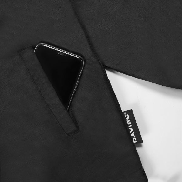 Black apron with a smartphone in the pocket and a Davies brand label.