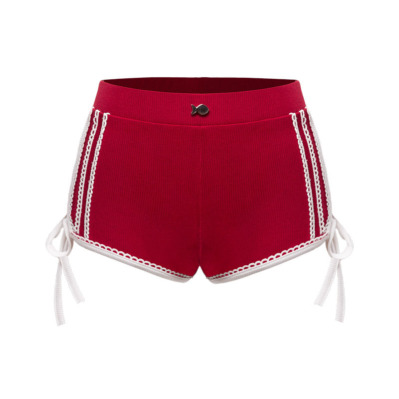Red shorts with white lace trim on a white background