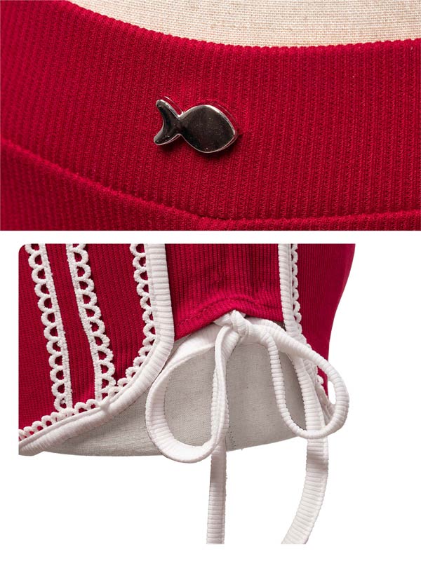 Red garment with a fish-shaped button and white lace details on a beige background
