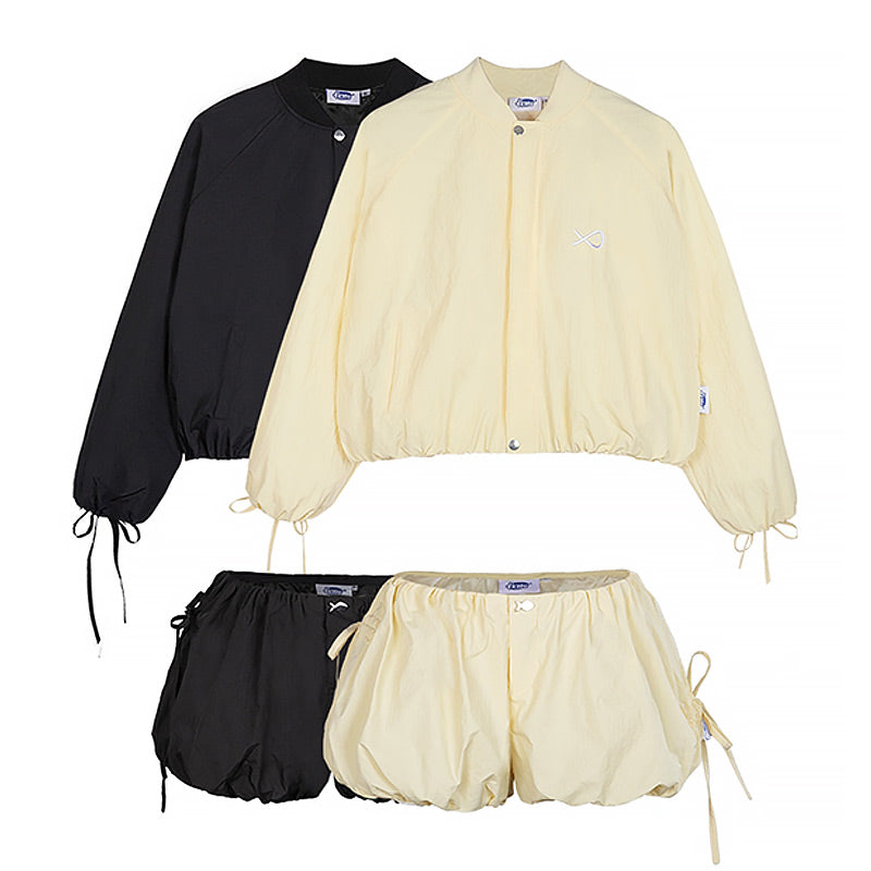 Black and beige bomber jacket and shorts set on a white background