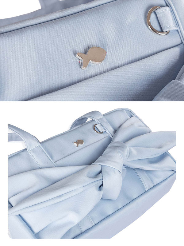 Light blue handbag with a whale emblem on a white background