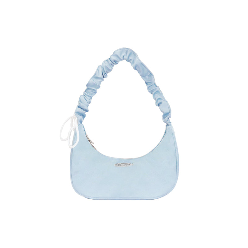 Light blue handbag with ruched strap on a white background
