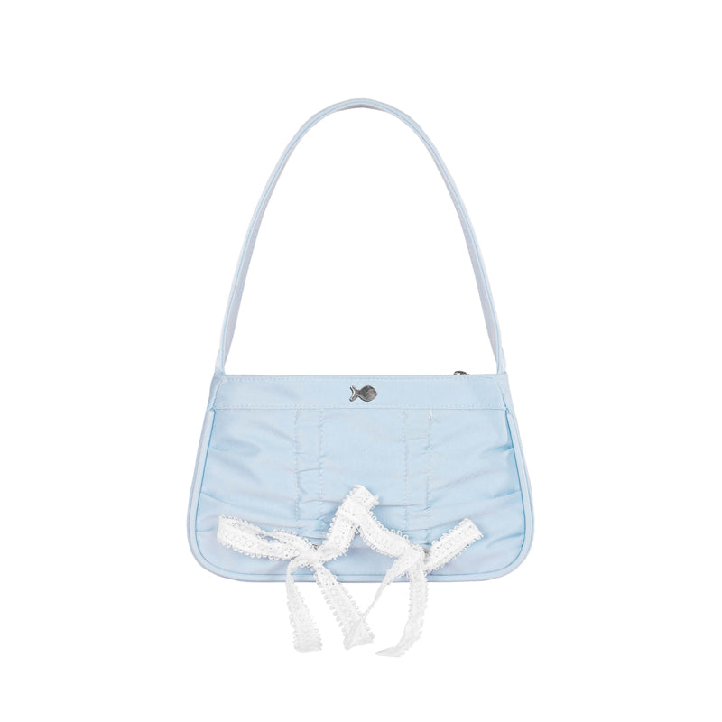 Light blue handbag with white lace details on a white background