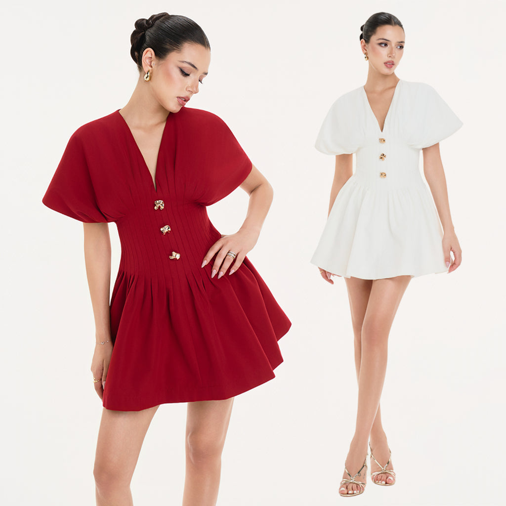 Two women wearing a red dress and a white dress with gold buttons on a white background