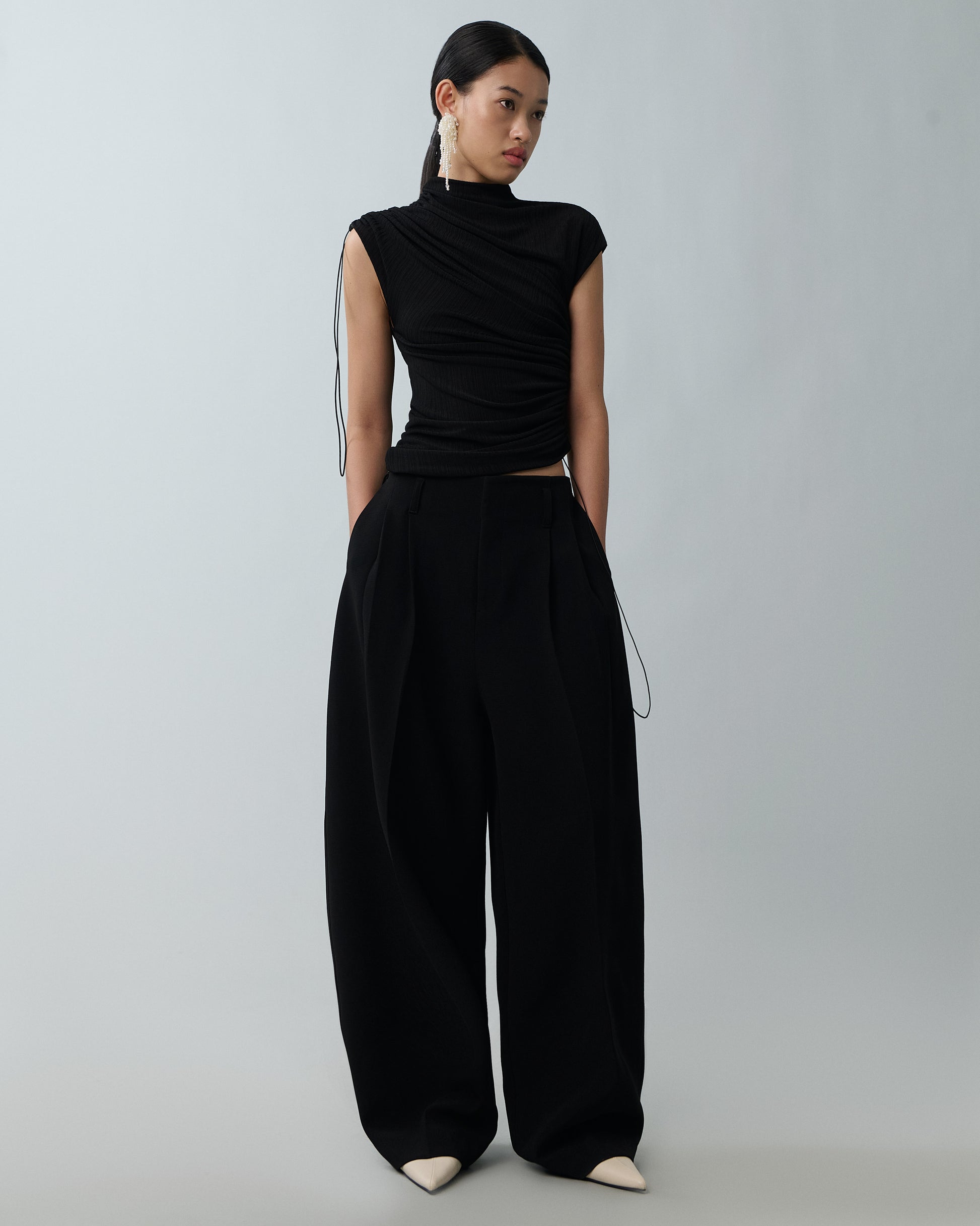Model wearing high-neck ribbed top