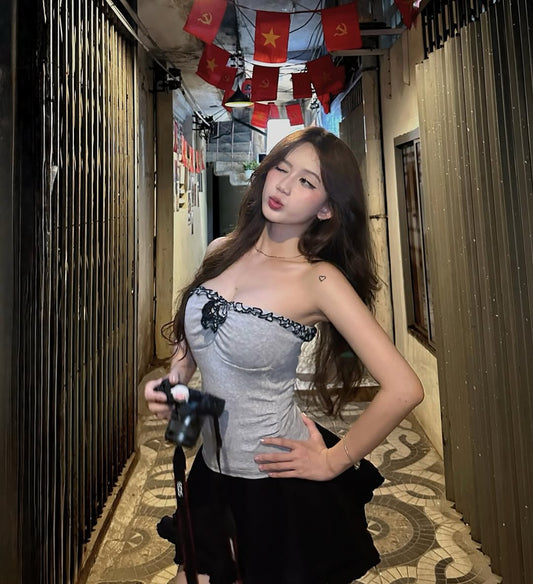 Woman posing in a corridor with decorative flags on the ceiling