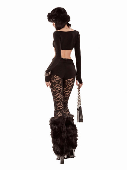 Woman wearing a black outfit with lace details and fur accents on a white background