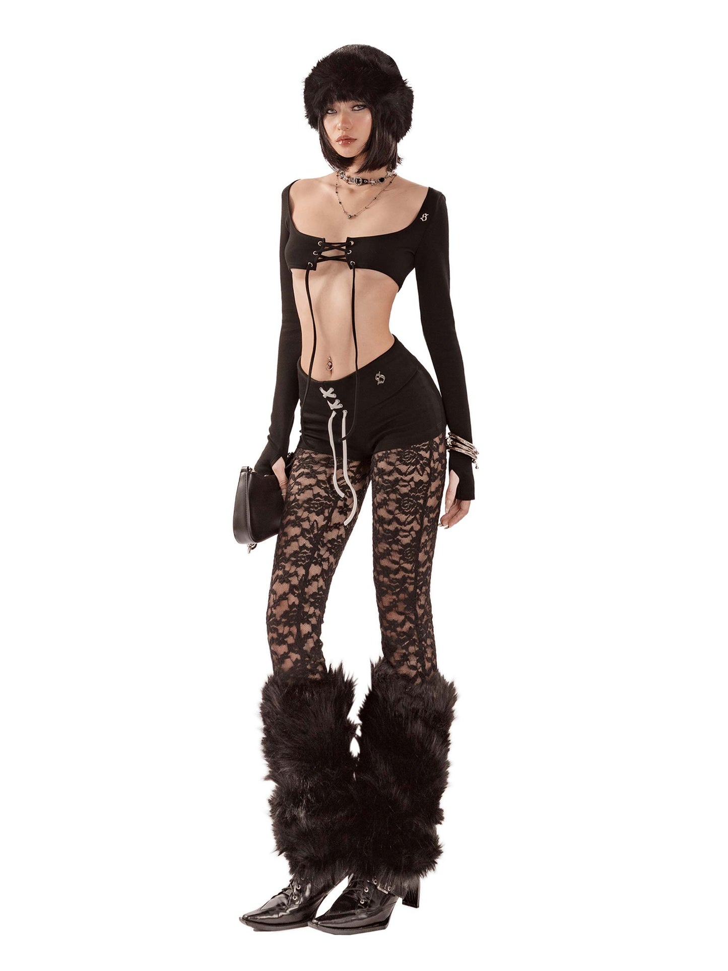 Person wearing a black outfit with lace pants and fur boots on a white background