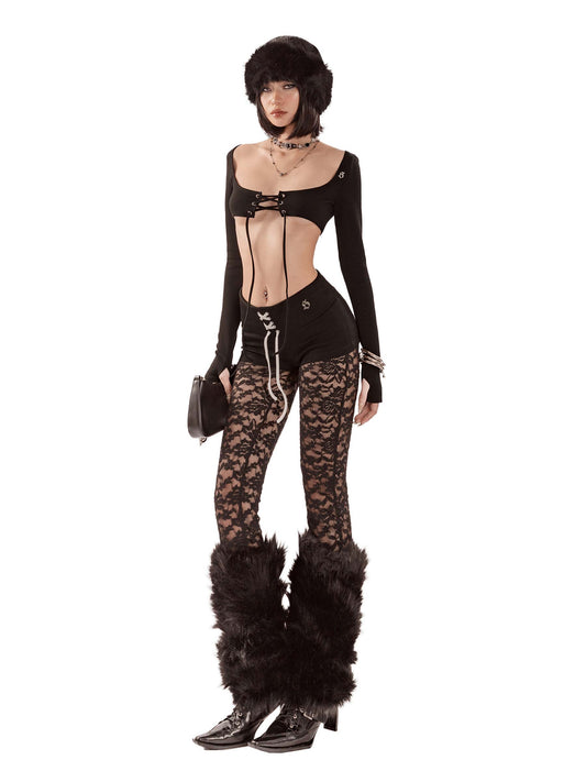 Person wearing a black outfit with lace pants and fur boots on a white background