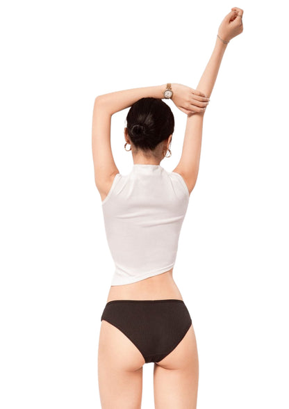 Person wearing a white sleeveless top and black underwear on a white background