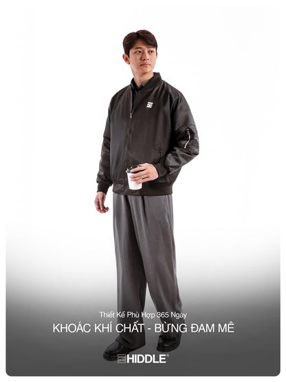 Person wearing a black tracksuit with a visible brand logo on a white background