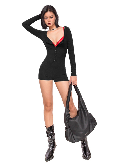 Woman in a black dress with red trim holding a black handbag on a white background
