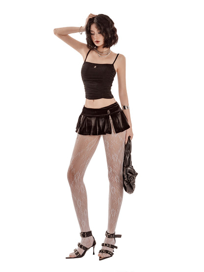 Woman wearing a black top, leather skirt, fishnet stockings, and high-heeled shoes on a white background