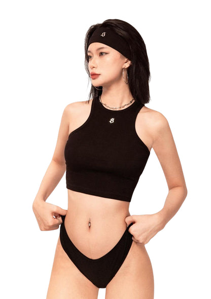 Woman wearing a black bikini set with a white background