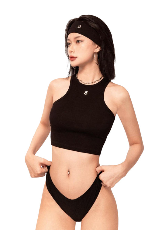 Woman wearing a black bikini set with a white background