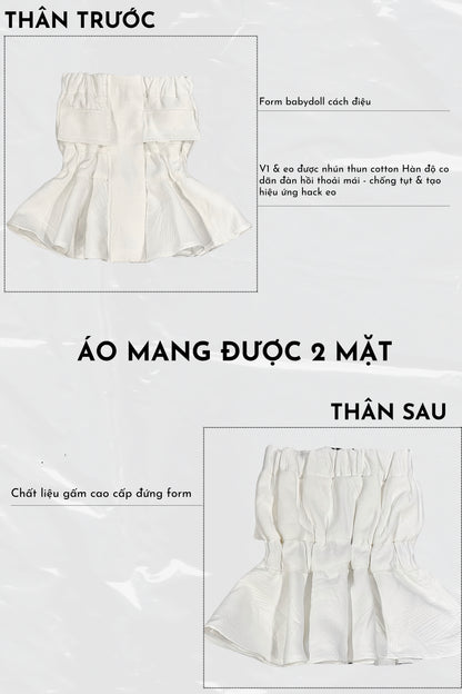 White babydoll dress with ruffled details on a white background