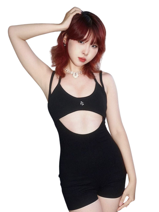 Person wearing a black outfit with cut-out design on a white background