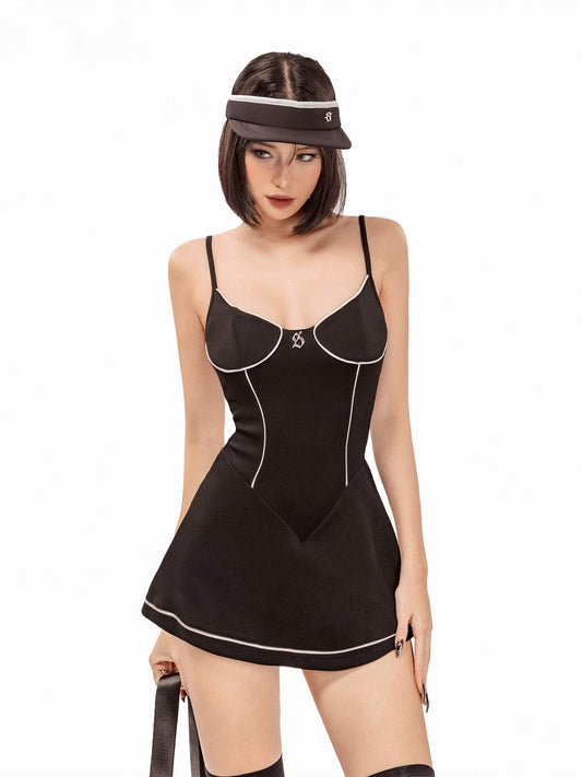 Woman wearing a black corset-style dress with white trim on a white background