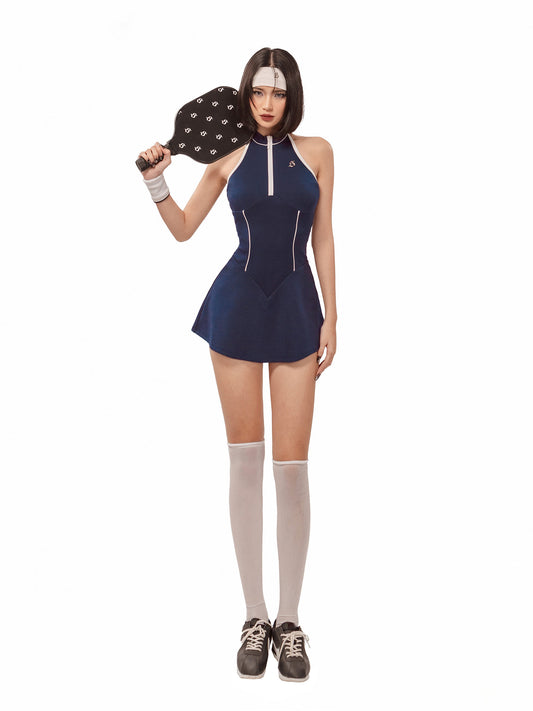 Person wearing a blue dress with a white zipper, holding a black and white paddle, on a white background