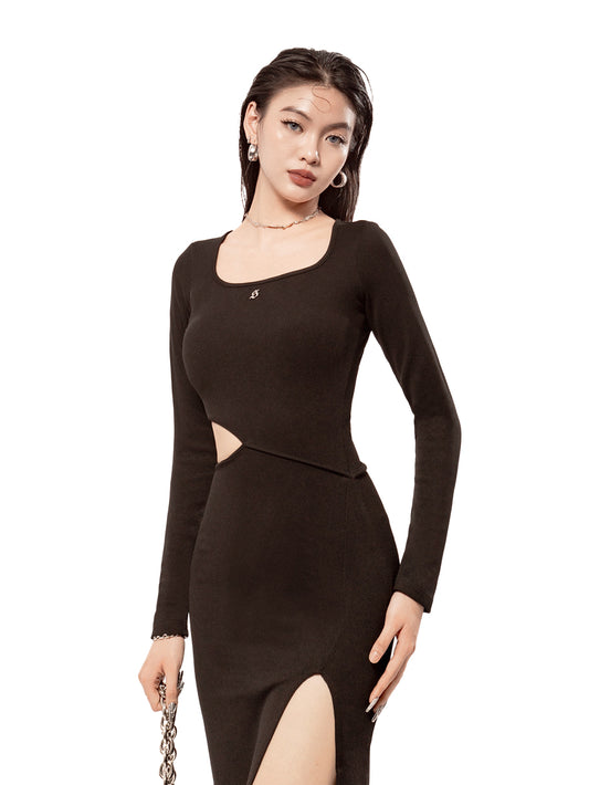 Woman wearing a black long-sleeve dress with cut-out details on a white background